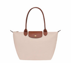 Bolso Longchanp Le Pliage con accesorios de viaje en su interior