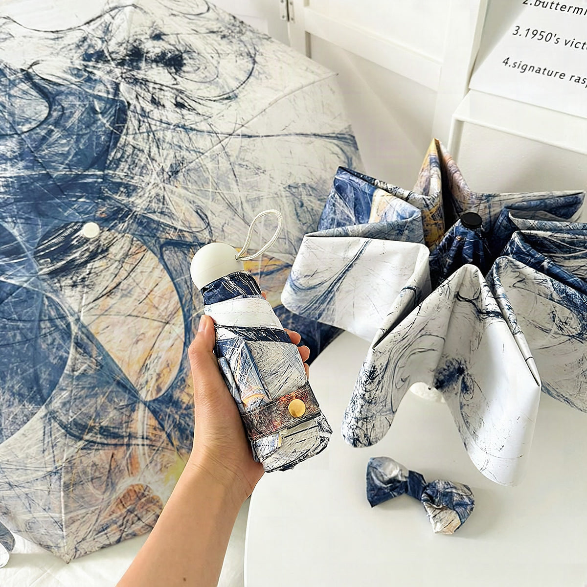 Paraguas plegable para mujer con diseño artístico y apertura automática
