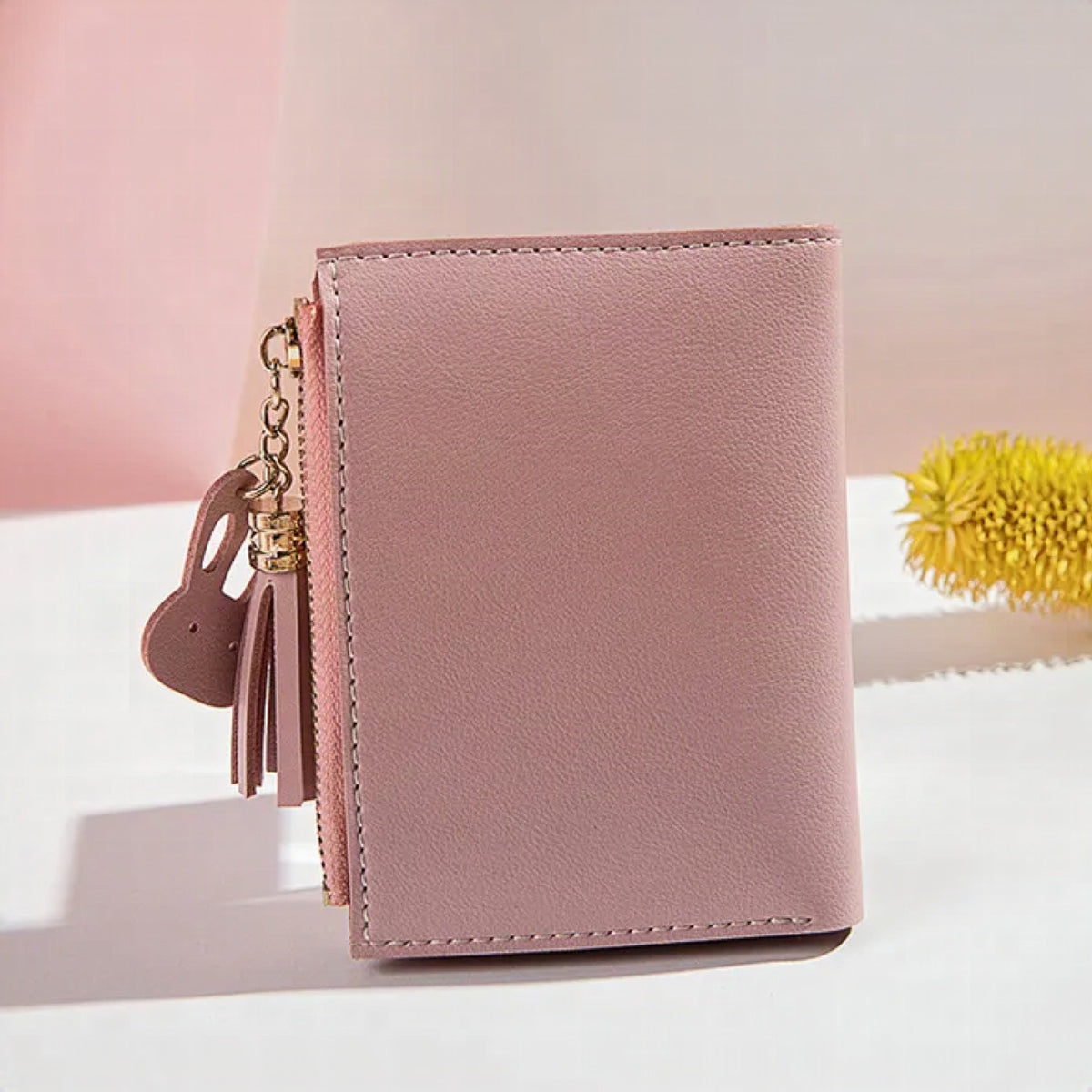 Monedero mini con borla decorativa