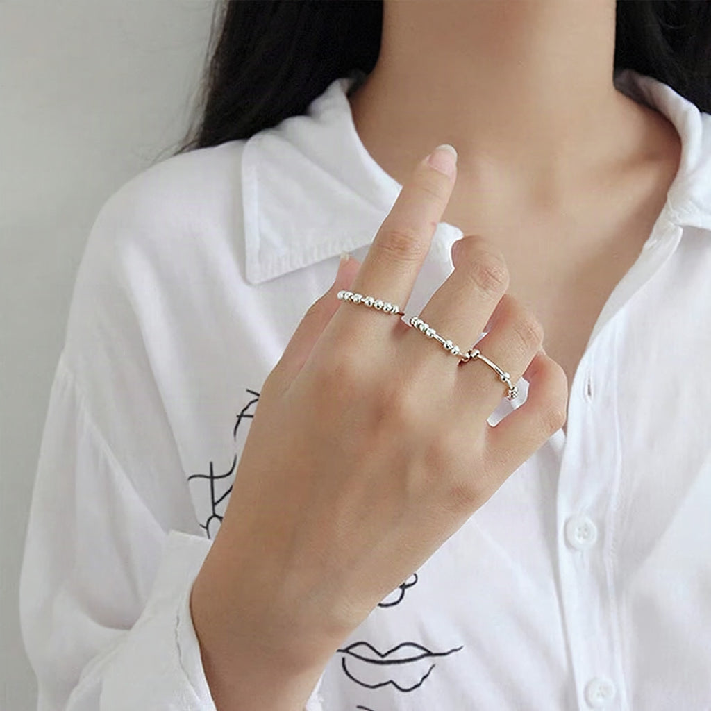 Anillo antiestrés giratorio de cuentas metálicas