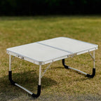 Mesa plegable de exterior en formato maleta para camping y balcón