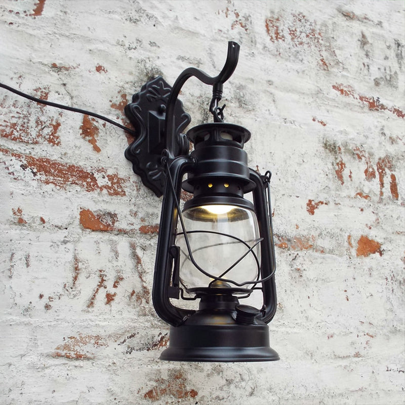 Aplique de pared estilo farol con cristal transparente, 1 luz, acabado negro o latón envejecido