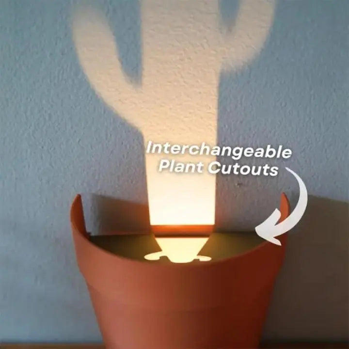 Maceta con proyección de luz y 7 siluetas de plantas para decoración de pared
