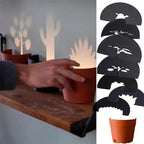 Maceta con proyección de luz y 7 siluetas de plantas para decoración de pared