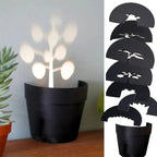 Maceta con proyección de luz y 7 siluetas de plantas para decoración de pared