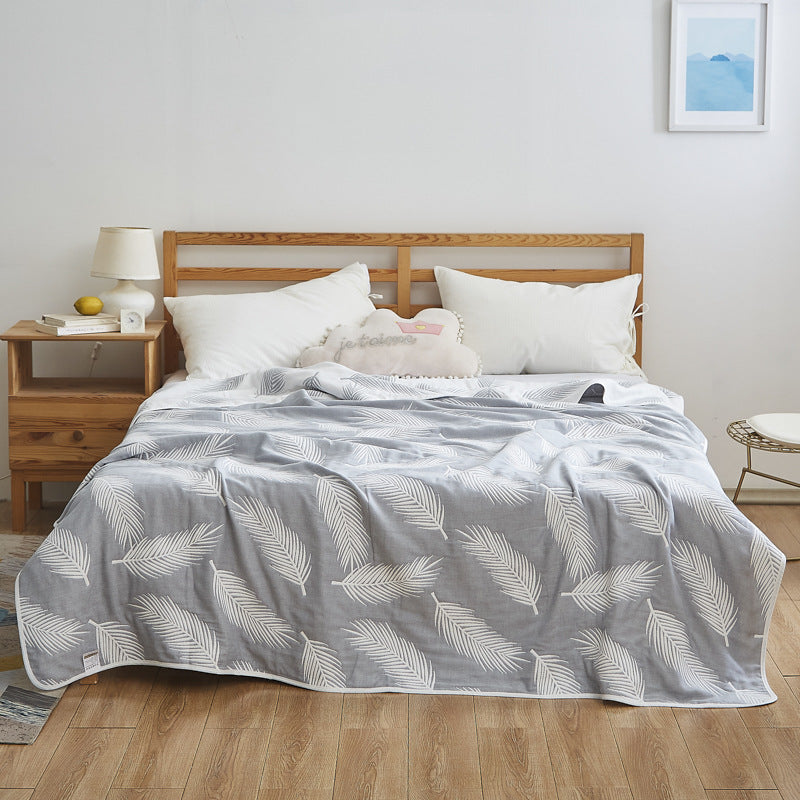 Manta elegante con sutil estampado de hojas