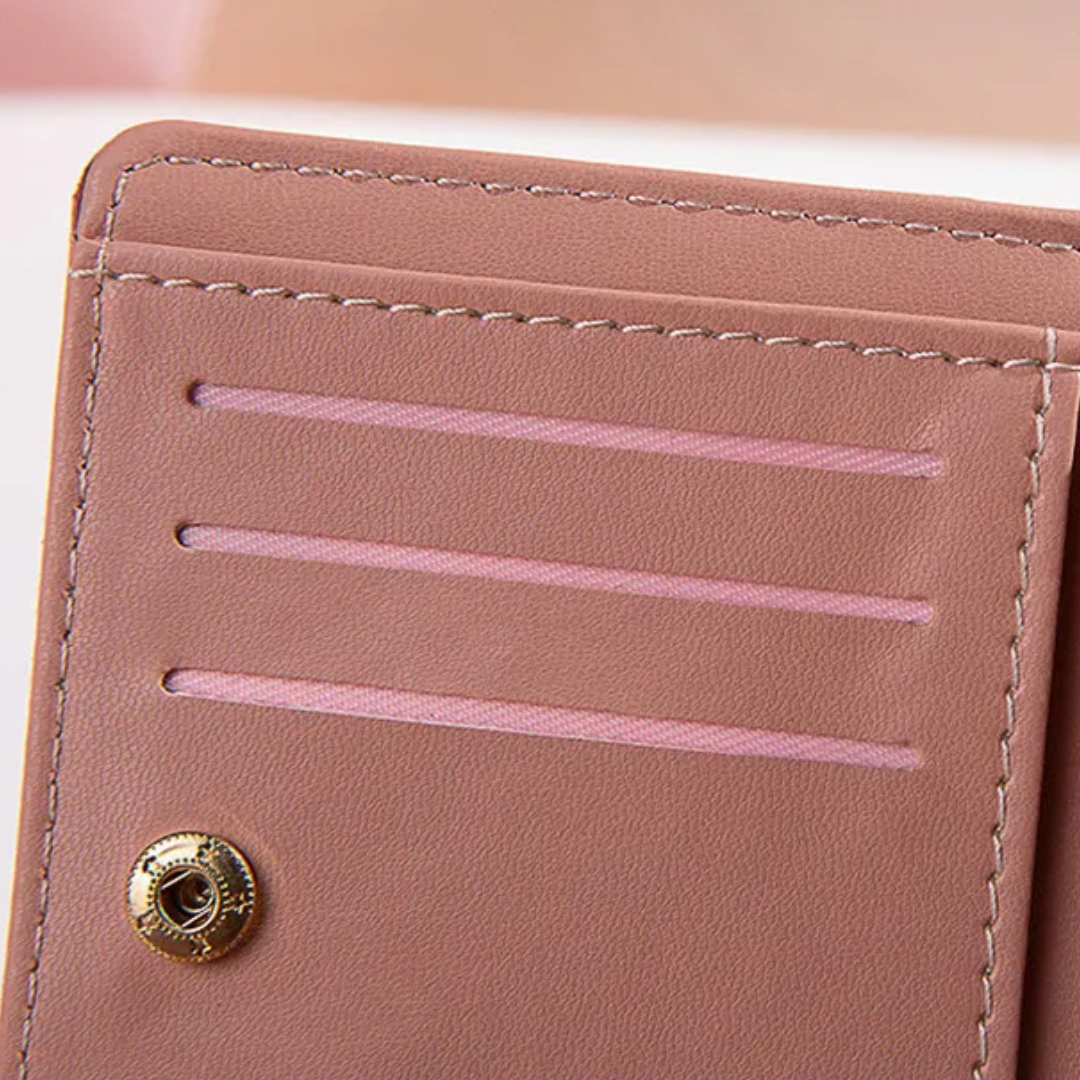 Monedero mini con borla decorativa