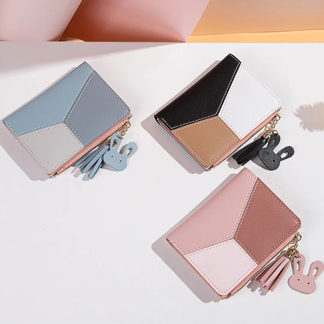 Monedero mini con borla decorativa