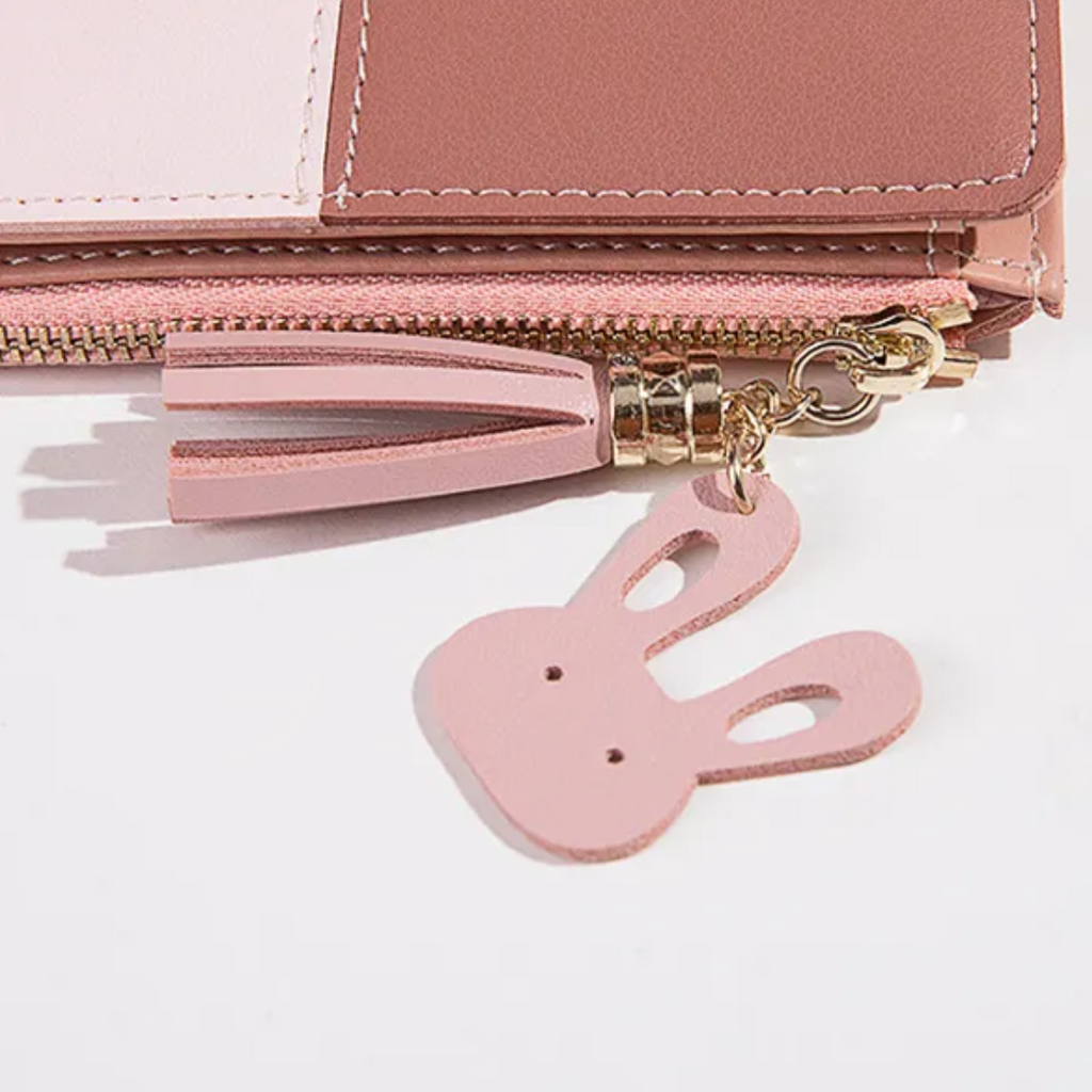 Monedero mini con borla decorativa