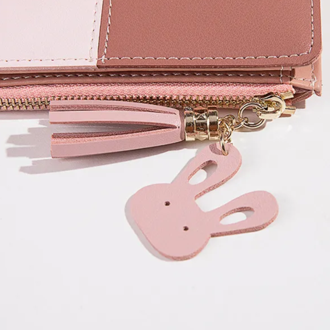 Monedero mini con borla decorativa