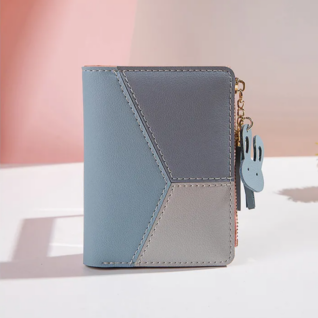 Monedero mini con borla decorativa