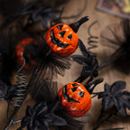 Rama decorativa de calabazas negras para Halloween