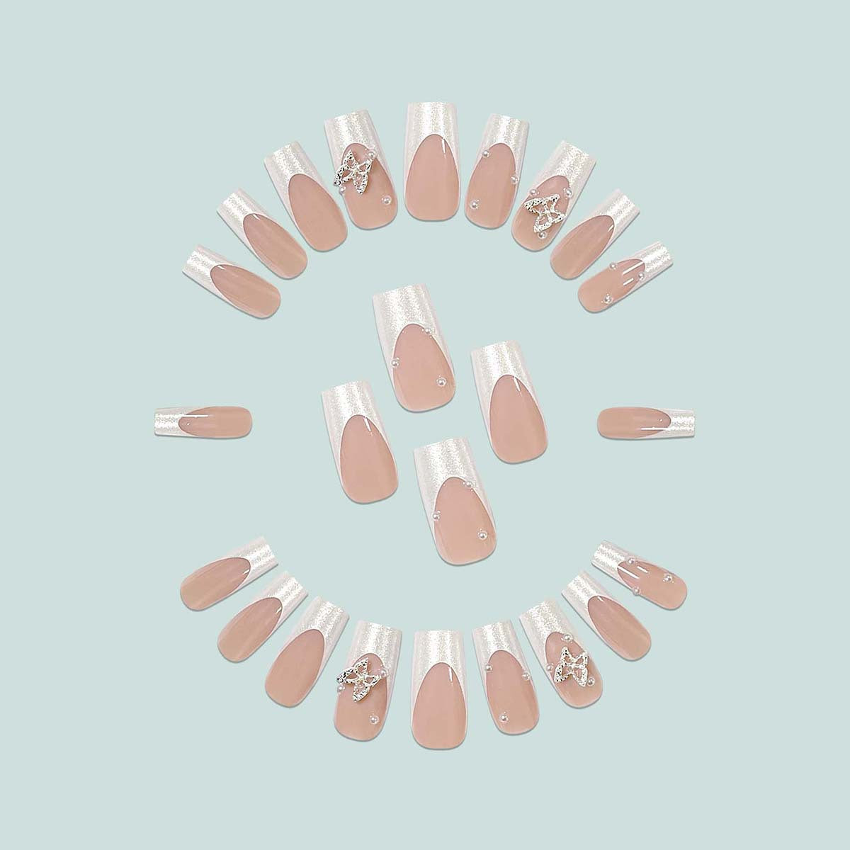 Uñas postizas francesas con purpurina y mariposas
